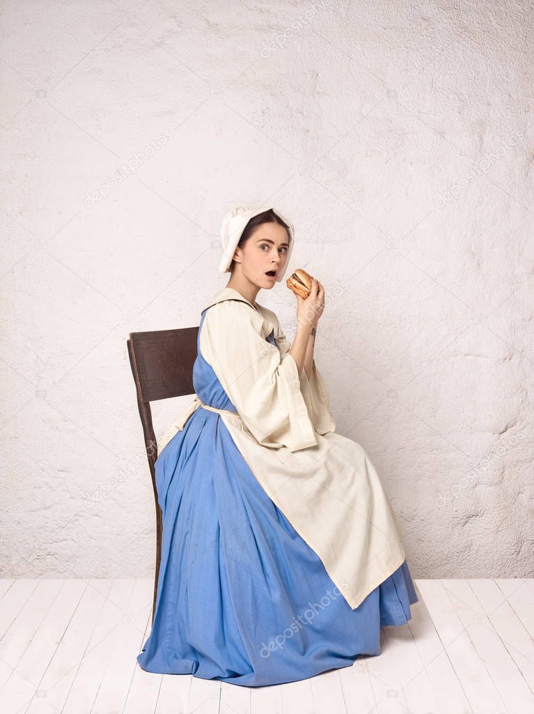 Medieval Woman in Historical Costume Wearing Corset Dress and Bonnet.