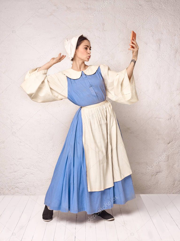 Medieval Woman in Historical Costume Wearing Corset Dress and Bonnet.