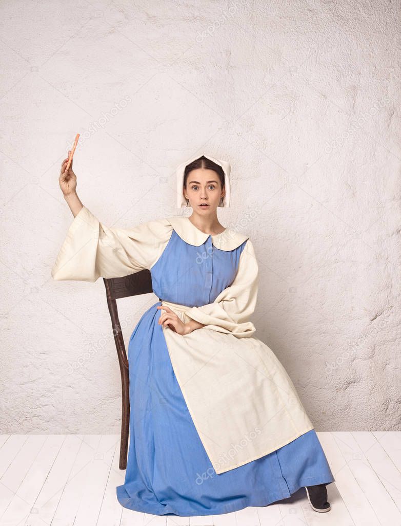 Medieval Woman in Historical Costume Wearing Corset Dress and Bonnet.