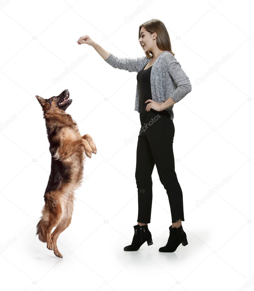 Woman with her dog over white background