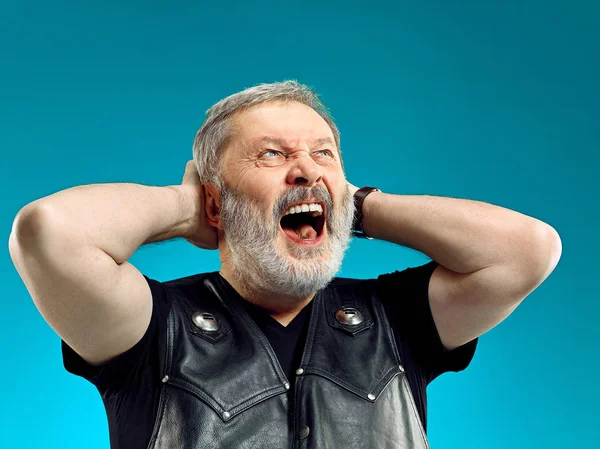 Smiling middle-aged man happy expression posing in front of a blue background with copy space — Stock Photo, Image