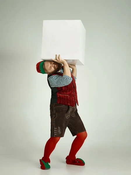 Friendly man dressed like a funny gnome posing on an isolated gray background — Stock Photo, Image