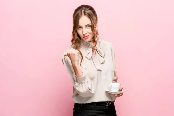 The young woman whispering a secret behind her hand over pink background — Stock Photo, Image