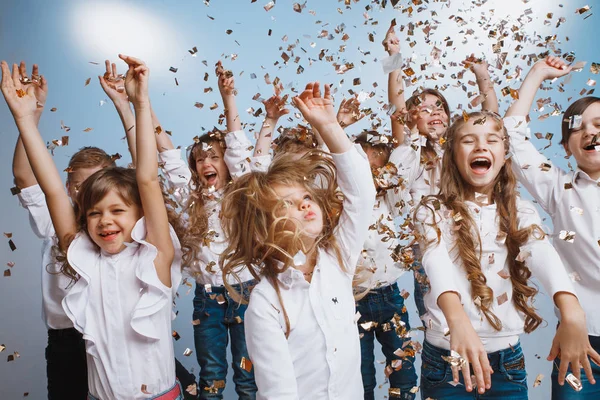 Adorable kids have fun together, throw colourful confetti, — Stock Photo, Image