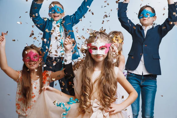 Adorable kids have fun together, throw colourful confetti, — Stock Photo, Image