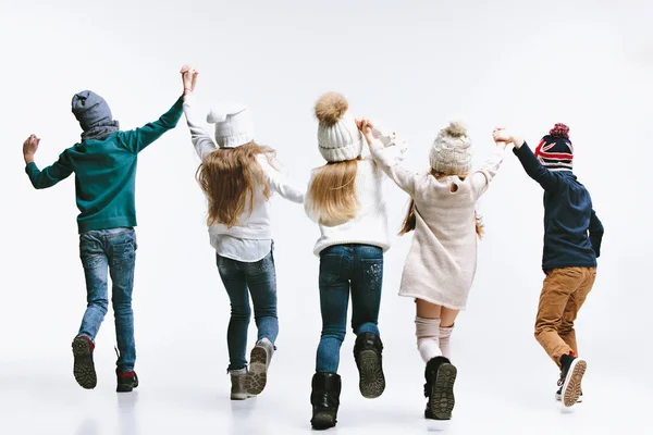 Grupo de niños en ropa de invierno brillante, aislados en blanco — Foto de Stock