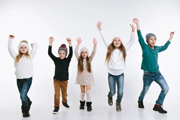 Groupe d'enfants en vêtements d'hiver lumineux, isolés sur blanc — Photo