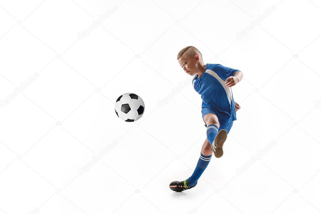 Young boy with soccer ball doing flying kick