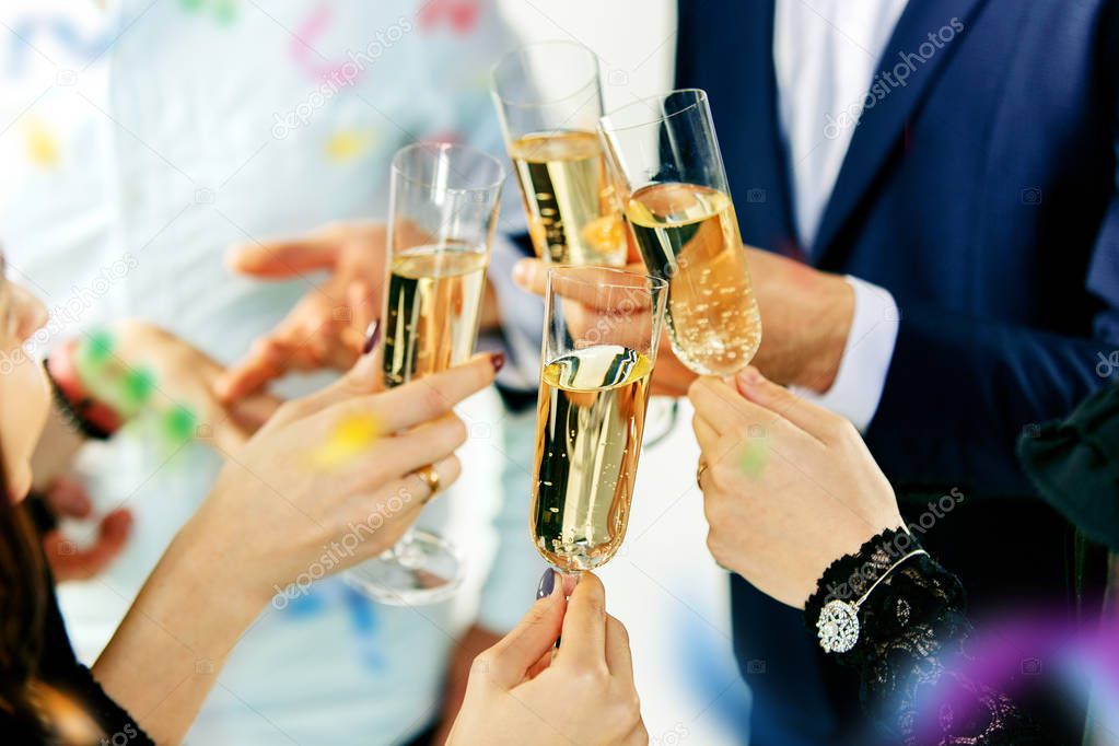 Celebration. Hands holding the glasses of champagne and wine making a toast.