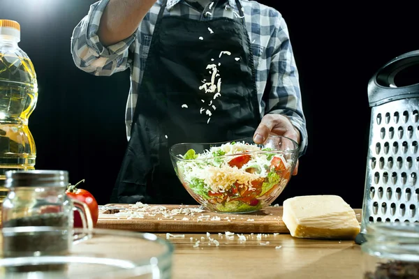 Preparing salad. Female chef cutting fresh vegetables. Cooking process. Selective focus