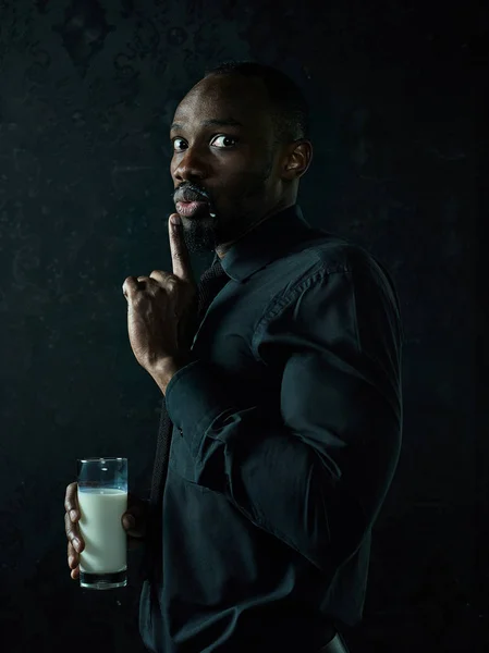 Healthy young african man holging milk