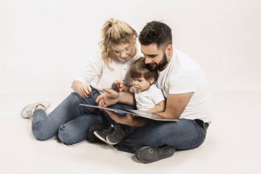 mutlu bir aile ile birlikte oturan ve üzerinde beyaz izole kamera gülümseyen çocuk