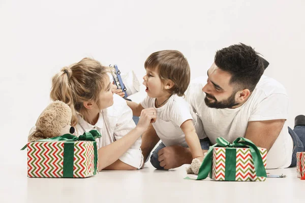 Happy family with kid together and smiling at camera isolated on white — Stock Photo, Image