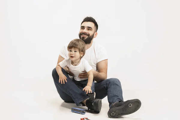 Famille heureuse avec enfant assis ensemble et souriant à la caméra isolé sur blanc — Photo