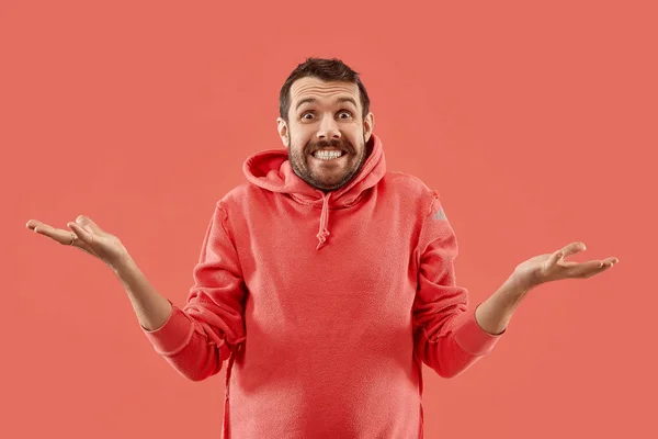 The young attractive man looking suprised isolated on coral — Stock Photo, Image