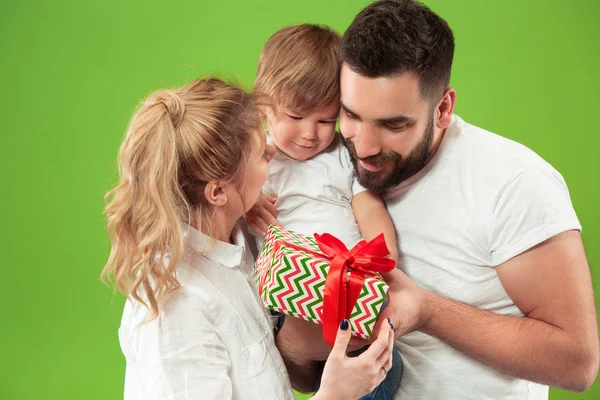 Happy family with kid together and smiling at camera isolated on green — Stock Photo, Image