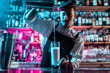 Uzman barmen gece kulübünde kokteyl hazırlıyor..