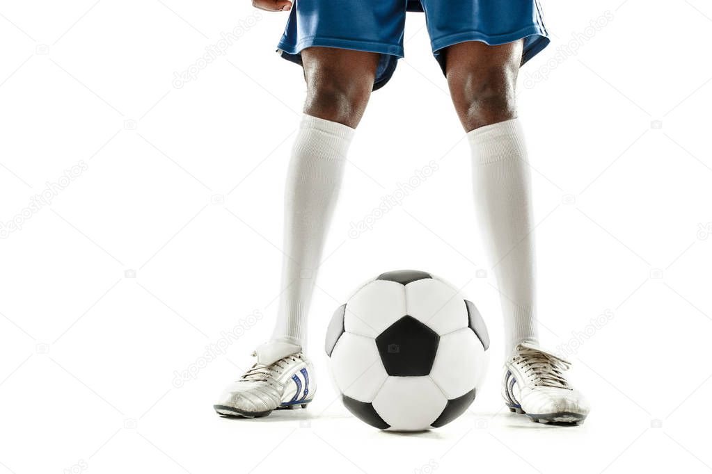 legs of soccer player close-up isolated on white