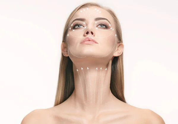 Close-up portrait of young, beautiful and healthy woman with arrows on her face — Stock Photo, Image