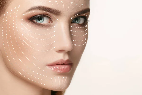 Close-up portrait of young, beautiful and healthy woman with arrows on her face — Stock Photo, Image