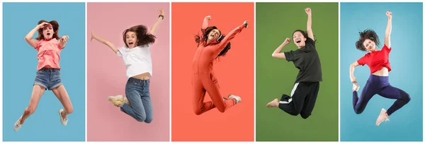 Freedom in moving. Pretty young woman jumping against orange background — Stock Photo, Image