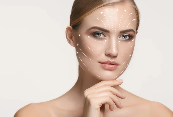 Close-up portrait of young, beautiful and healthy woman with arrows on her face — Stock Photo, Image