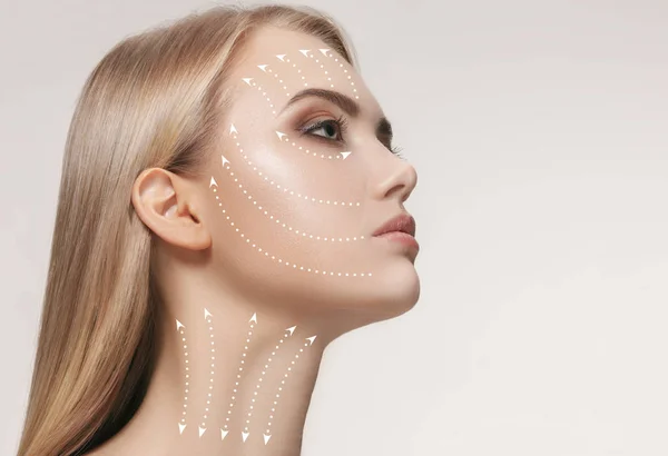 Close-up portrait of young, beautiful and healthy woman with arrows on her face — Stock Photo, Image