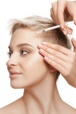 People, Lips, cosmetology, plastic surgery and beauty concept - beautiful young woman face and hand with syringe making injection