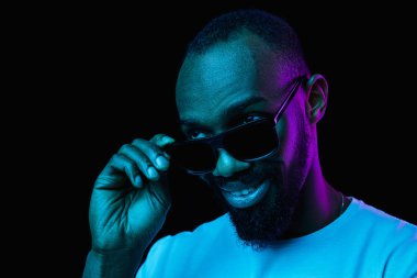 The neon portrait of a young smiling african man