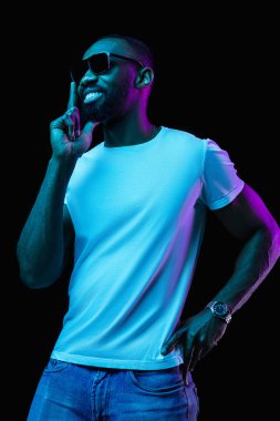 The neon portrait of a young smiling african man