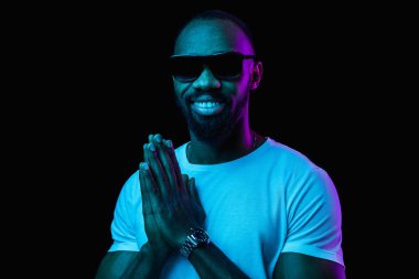 The neon portrait of a young smiling african man