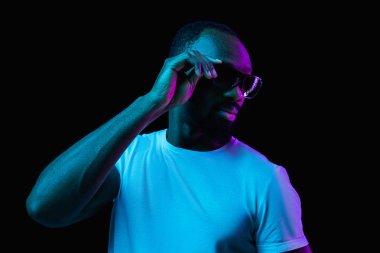 The neon portrait of a young smiling african man