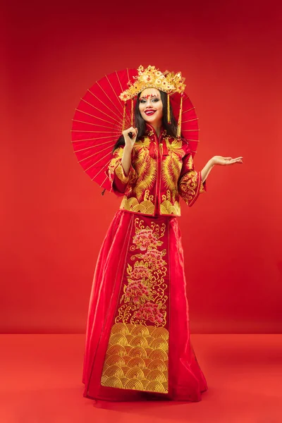Chinese traditional woman. Beautiful young girl wearing in national costume