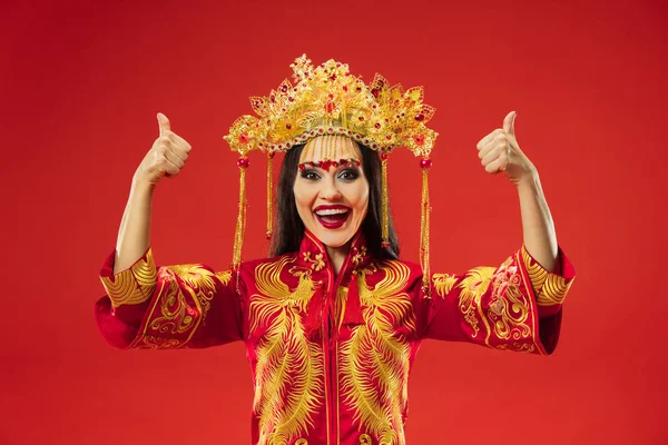 Chinese traditional woman. Beautiful young girl wearing in national costume