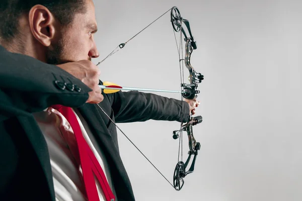 Businessman aiming at target with bow and arrow, isolated on white background — Stock Photo, Image