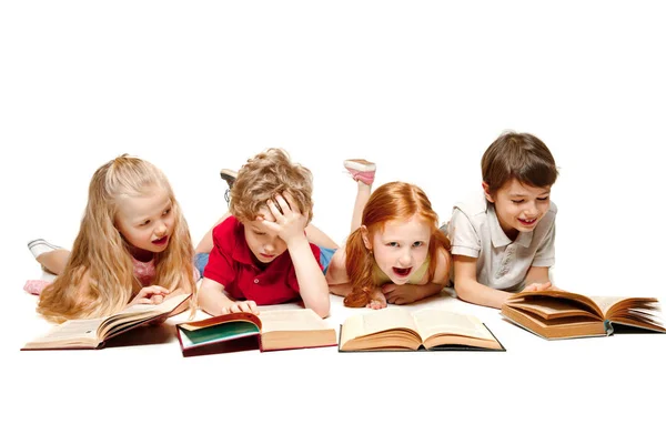 The kids boy and girls laying with books isolated on white — Stock Photo, Image