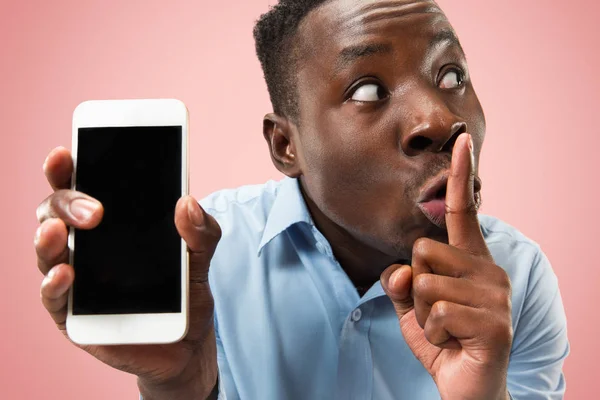 Beltéri portré vonzó fiatal fekete férfi tartja üres smartphone — Stock Fotó