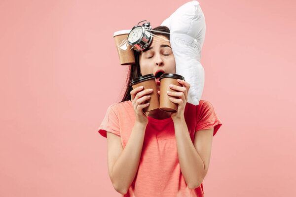 Tired woman at home having too much work. Bored businesslady with pillow and coffee
