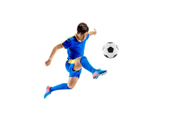 Young boy with soccer ball doing flying kick