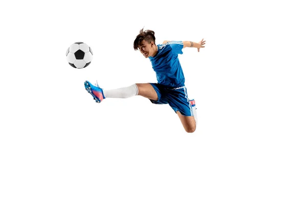 Young boy with soccer ball doing flying kick