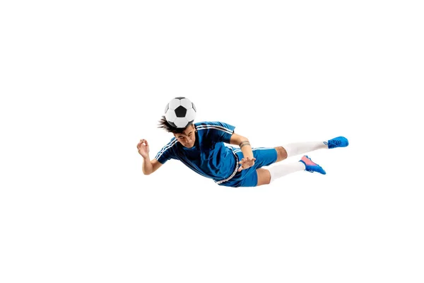 Young boy with soccer ball doing flying kick