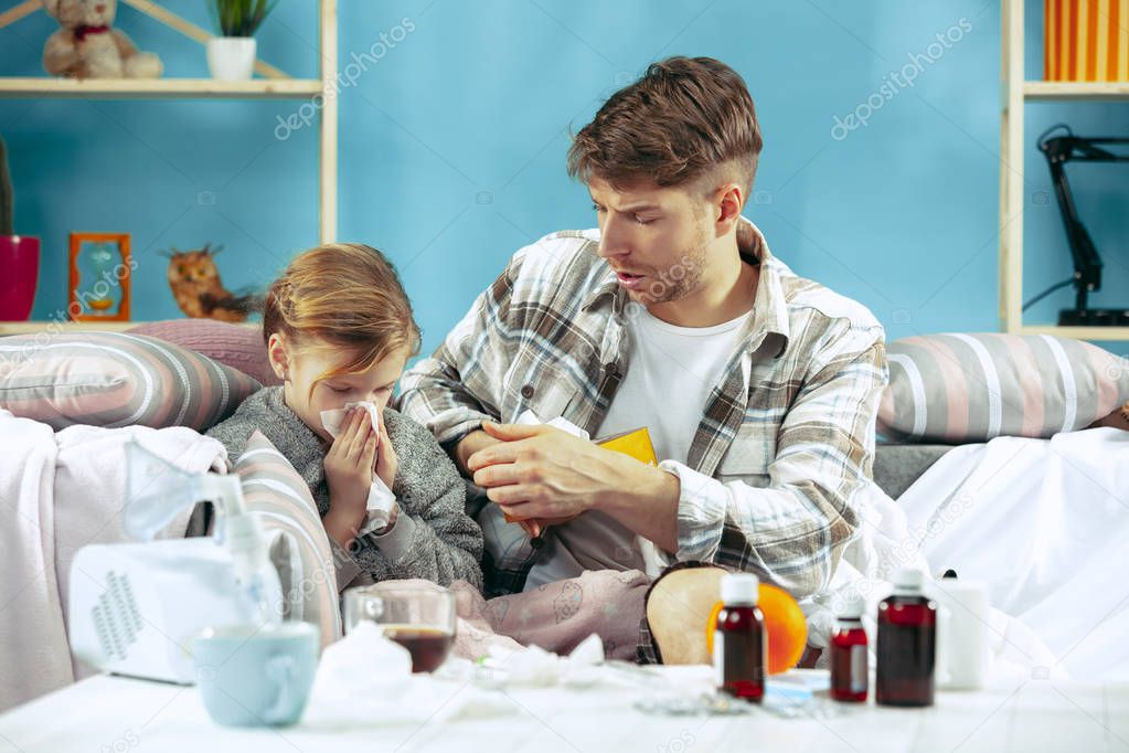 Sick man with daughter at home. The ill family.