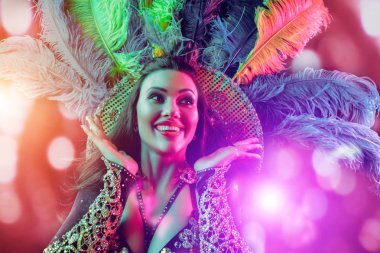 Beautiful young woman in carnival peacock costume clipart