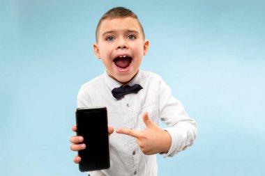 Kapalı boş smartphone tutan çekici genç çocuk portresi