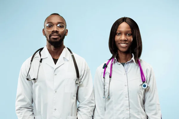 The female and male f happy afro american doctors on blue background