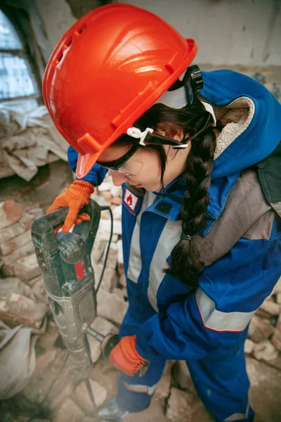 Frau trägt Helm mit männlichem Arbeitsgerät — Stockfoto