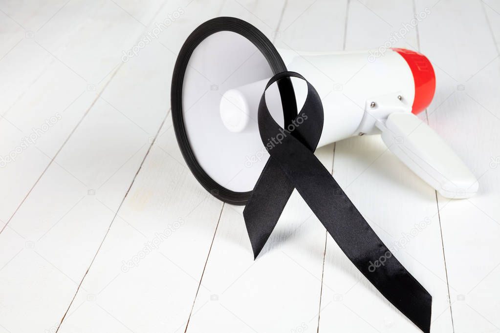 Black ribbon-symbol of fight against melanoma and skin cancer.