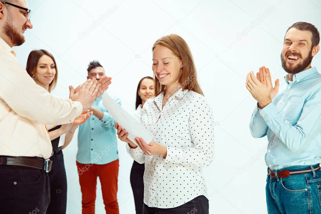 Boss approving and congratulating young successful employee