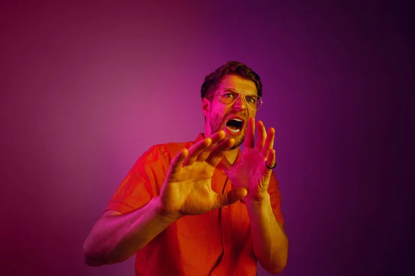 Portrait of the scared man on pink — Stock Photo, Image