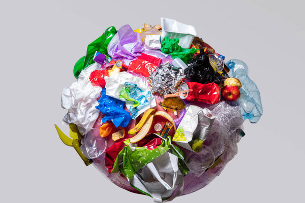 A globe of the earth with trash over white background, the concept of ecology problem